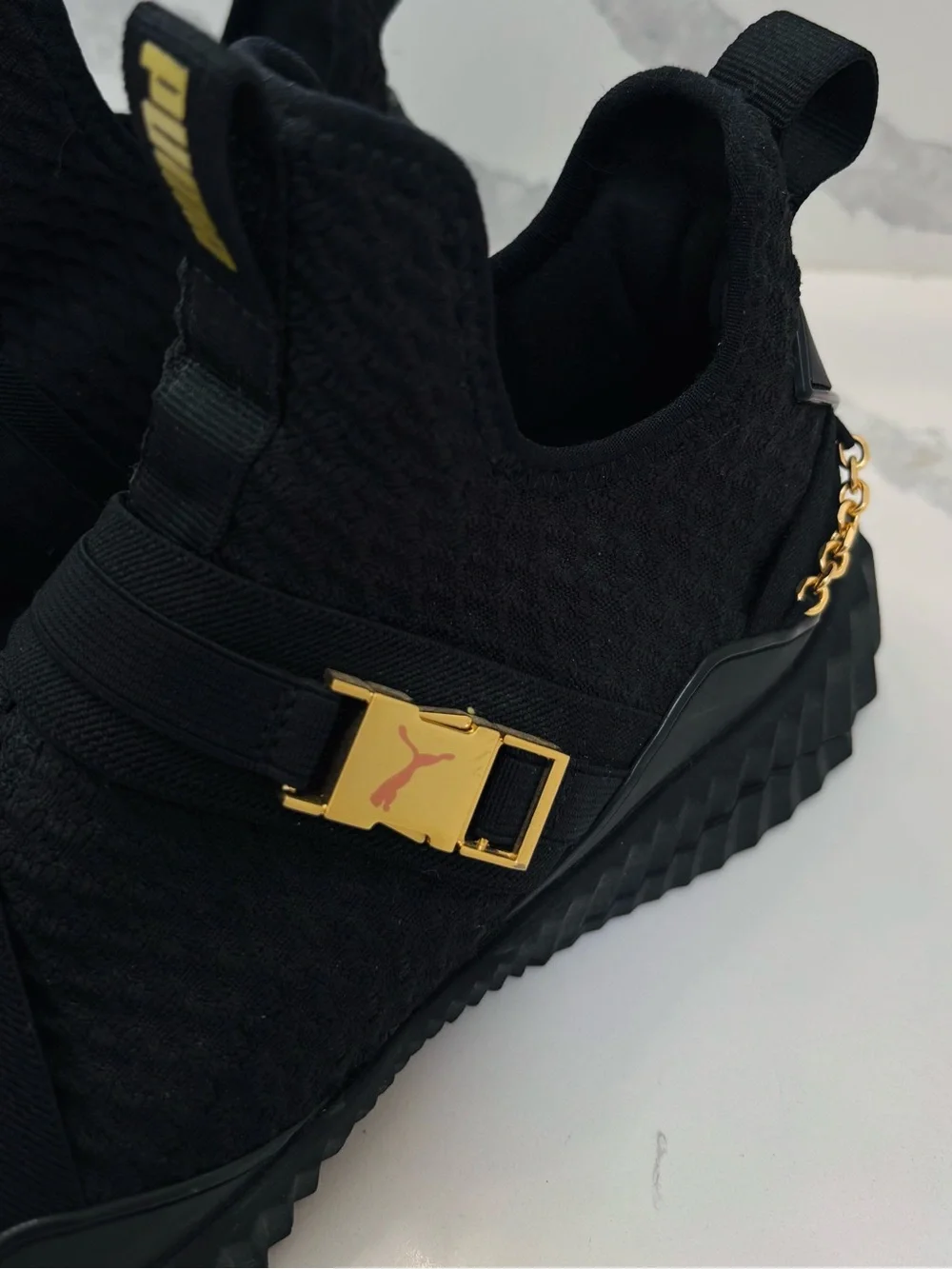 PUMA Women’s 10 Defy Mid Black Training Sneakers with Gold Buckle and Chain